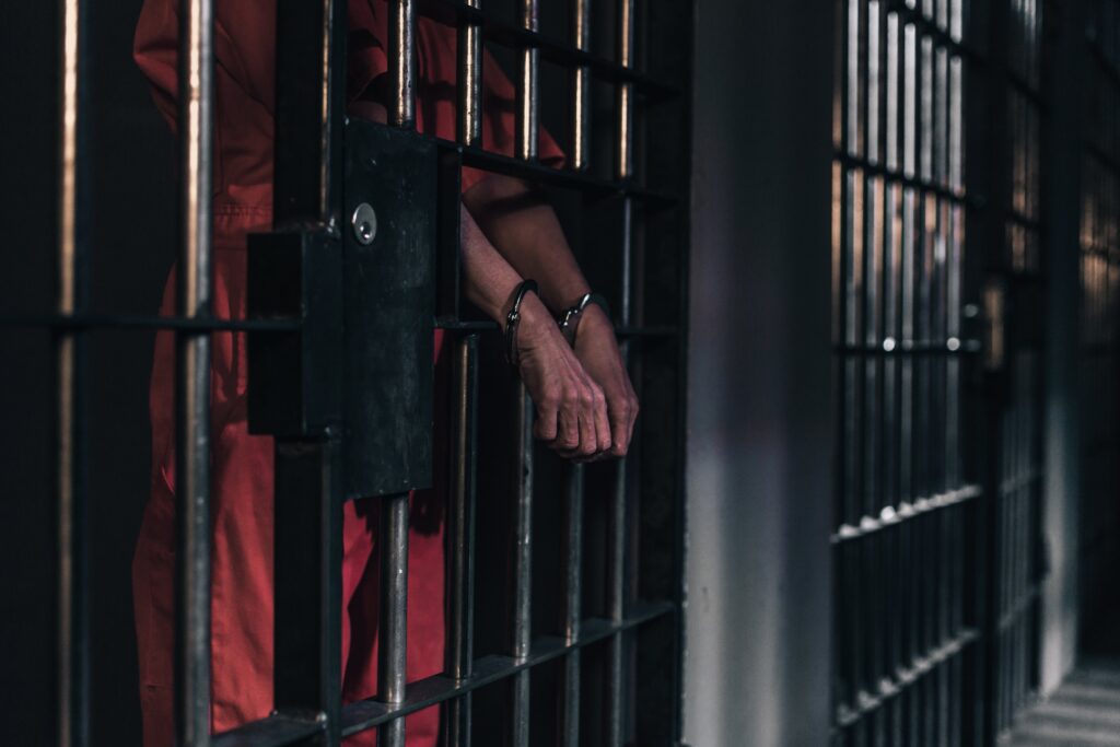 hands-in-handcuffs-in-a-prison-cell